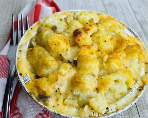 A close up of a bowl of food with potatoes