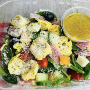 A salad with dressing in the middle of it.