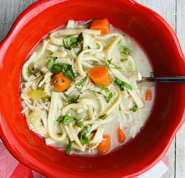 A bowl of soup with noodles and vegetables.
