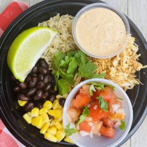 A black plate with rice, corn and beans.